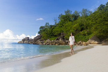 Image showing A beautiful woman walking on the beach