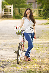 Image showing Girl with her bicycle