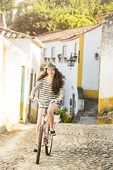 Image showing Happy girl riding a bicycle 