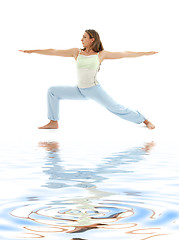 Image showing virabhadrasana warrior pose on white sand #4