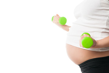 Image showing Pregnant girl lifting dumbbells isolated on white