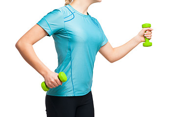 Image showing Athletic woman works out with green dumbbells