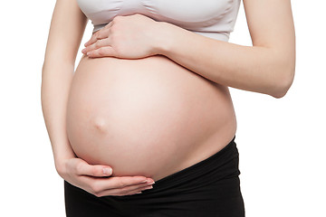 Image showing Pregnant woman holding belly with arms 