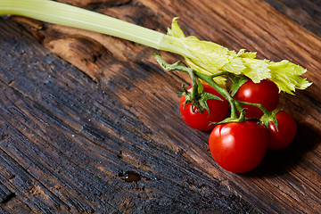 Image showing Fresh Raw Celery and Tomatoes Vegetable on Brown Wooden background