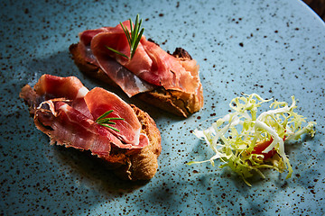 Image showing Two slice of Spanish tapas with jamon
