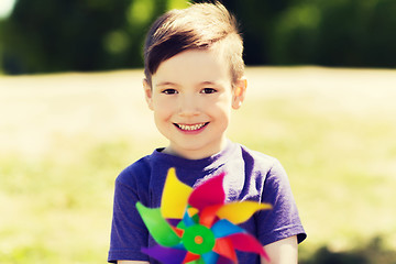 Image showing happy little boy with colorful pinwheel at summer