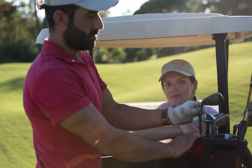 Image showing couple in buggy on golf course