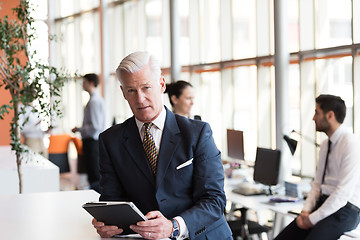 Image showing senior business man working on tablet computer