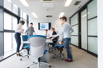 Image showing business people group entering meeting room, motion blur