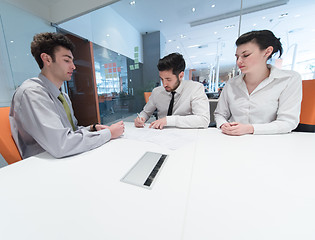 Image showing young couple signing contract documents on partners back