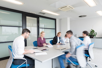 Image showing business people group entering meeting room, motion blur