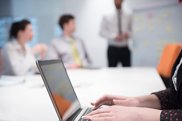 Image showing young business woman on meeting  using laptop computer