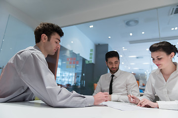 Image showing young couple signing contract documents on partners back