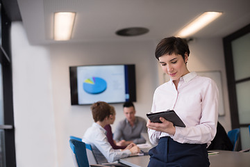 Image showing hispanic businesswoman with tablet at meeting room