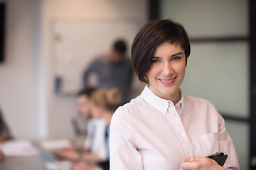 Image showing hispanic businesswoman with tablet at meeting room