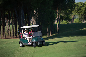 Image showing couple in buggy on golf course