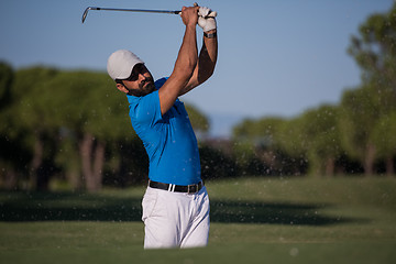 Image showing pro golfer hitting a sand bunker shot