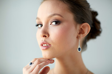 Image showing beautiful woman with earring and finger ring