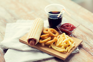 Image showing close up of fast food snacks and drink on table