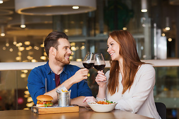 Image showing happy couple dining and drink wine at restaurant