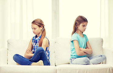 Image showing quarreled little girls sitting on sofa at home