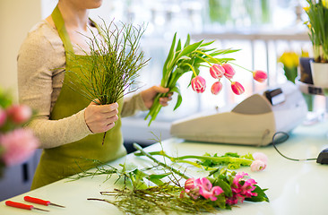 Image showing close up of florist making bunch at flower shop