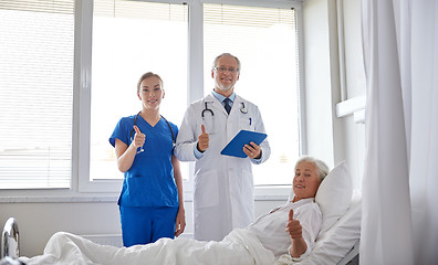 Image showing doctor and nurse visiting senior woman at hospital