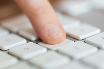 Image showing close up of finger pressing button on keyboard