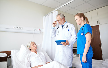 Image showing doctor and nurse visiting senior woman at hospital