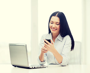 Image showing smiling businesswoman or student with laptop