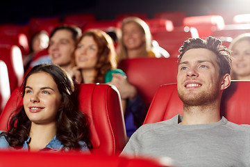 Image showing happy friends watching movie in theater