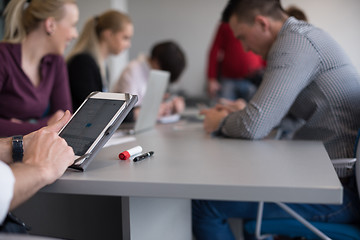 Image showing close up of  businessman hands  using tablet on meeting