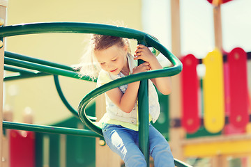 Image showing happy little girl climbing on children playground