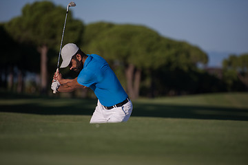 Image showing pro golfer hitting a sand bunker shot