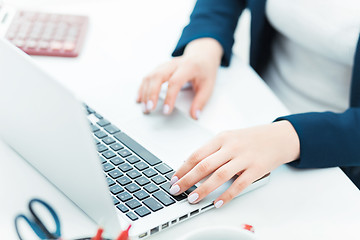 Image showing The female hands on the keyboard of her laptop computer