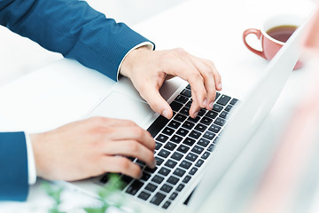 Image showing The male hands on the keyboard of laptop computer