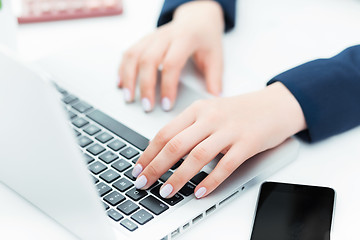 Image showing The female hands on the keyboard of her laptop computer