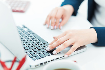 Image showing The female hands on the keyboard of her laptop computer