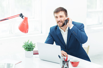 Image showing Portrait of businessman talking on phone in office