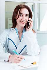 Image showing Woman doctor sitting at the table