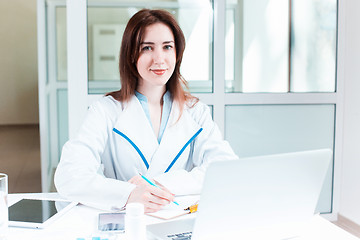 Image showing Woman doctor sitting at the table