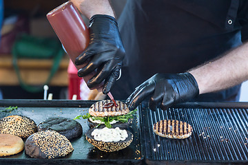 Image showing Beef burgers ready to serve on food stall.