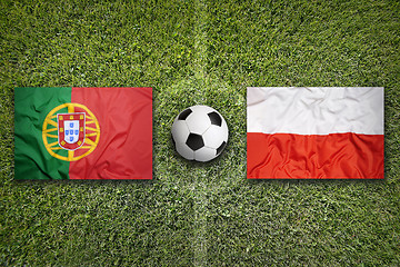 Image showing Portugal vs. Poland flags on soccer field