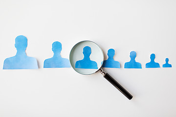 Image showing close up of paper human shapes on white board