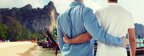 Image showing close up of male gay couple hugging on beach