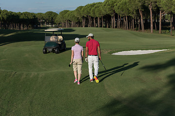 Image showing couple walking on golf course