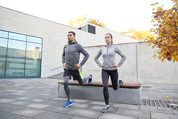 Image showing couple doing lunge exercise on city street
