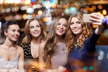 Image showing women with smartphone taking selfie at night club