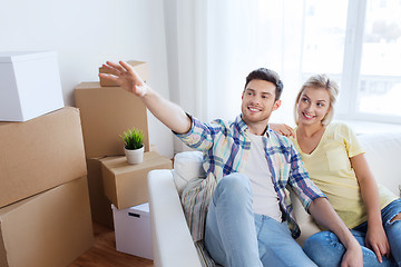 Image showing couple with boxes moving to new home and dreaming