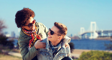 Image showing happy teenage couple in shades having fun outdoors